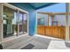 Covered patio with access to home, featuring a sliding glass door and concrete steps at 9422 E 58Th Pl, Denver, CO 80238