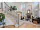 Elegant living room showcasing a cozy fireplace, high ceilings, and stylish staircase at 6971 S Netherland Way, Aurora, CO 80016
