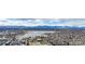 Expansive aerial view of a city, lake, and mountain range, with many homes and buildings at 3142 W 20Th Ave, Denver, CO 80211