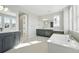 Bright primary bathroom with double vanities, soaking tub and neutral color palette at 3378 Backdrop Ct, Castle Rock, CO 80108