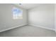 A carpeted bedroom illuminated by a single window and light gray walls at 3378 Backdrop Ct, Castle Rock, CO 80108