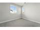 A carpeted bedroom featuring two windows for ample sunlight and light gray walls at 3378 Backdrop Ct, Castle Rock, CO 80108
