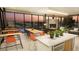 Open-concept clubhouse with fireplace, comfortable seating, and dining area with view at 3378 Backdrop Ct, Castle Rock, CO 80108