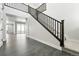 Inviting entryway with dark wood staircase and luxury vinyl plank flooring at 3378 Backdrop Ct, Castle Rock, CO 80108
