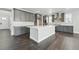 Modern kitchen featuring gray cabinets, a large white island, and stainless steel appliances with sleek hardware at 3378 Backdrop Ct, Castle Rock, CO 80108