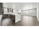 Bright open kitchen with stainless steel appliances, quartz countertops, and spacious island, flowing into the living area at 3378 Backdrop Ct, Castle Rock, CO 80108