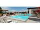 Resort-style swimming pool with lounge chairs, umbrellas, and a water fountain, perfect for relaxation and recreation at 3378 Backdrop Ct, Castle Rock, CO 80108