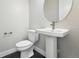 Powder room featuring modern fixtures, including a pedestal sink and oval mirror at 3378 Backdrop Ct, Castle Rock, CO 80108