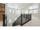 Bright and airy staircase featuring dark wood railings and carpeted steps at 3378 Backdrop Ct, Castle Rock, CO 80108