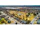 Stunning aerial view of a neighborhood park with tennis courts, trails, and playground near a residential community and Denver skyline at 6306 Xavier St, Arvada, CO 80003