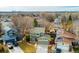 Aerial view of a green home with a well-manicured front yard in a suburban neighborhood at 6306 Xavier St, Arvada, CO 80003