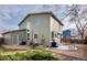 Spacious backyard showing patio, grill, lush greenery, and a glimpse of surrounding homes at 6306 Xavier St, Arvada, CO 80003