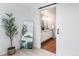 Bright bathroom view from bedroom featuring a vanity with an oval mirror and cabinet at 6306 Xavier St, Arvada, CO 80003