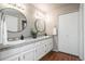 Spacious bathroom with dual sinks, a large mirror, and a separate closet at 6306 Xavier St, Arvada, CO 80003