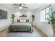Cozy bedroom with a queen-size bed, plants and natural light from the window at 6306 Xavier St, Arvada, CO 80003