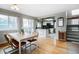 Inviting dining area, open to the kitchen, with sliding doors to backyard and staircase to upper level at 6306 Xavier St, Arvada, CO 80003