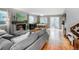 Spacious living room featuring a cozy fireplace, wood floors, and sliding door to patio at 6306 Xavier St, Arvada, CO 80003