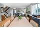 Inviting dining area, open to the living room, with staircase, hardwood floors, and neutral tones at 6306 Xavier St, Arvada, CO 80003