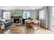 Open-concept living room with a dining area, fireplace, and plenty of natural light at 6306 Xavier St, Arvada, CO 80003