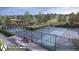 Aerial view of the community's blue tennis courts with players and perimeter landscape at 17143 W 91St Ln, Arvada, CO 80007