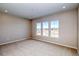 Neutral bedroom featuring three large windows at 8606 Hotchkiss St, Littleton, CO 80125