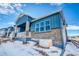 Stylish blue home with a covered porch and brick accents at 8606 Hotchkiss St, Littleton, CO 80125