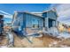 Stylish blue home with covered porch and brick accents at 8606 Hotchkiss St, Littleton, CO 80125