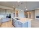 Elegant kitchen boasts quartz island with sink, stainless appliances, modern cabinetry and wood flooring for a stylish design at 8606 Hotchkiss St, Littleton, CO 80125