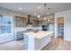 Bright kitchen with a spacious island, stainless steel appliances, and sleek cabinetry offer both style and functionality at 8606 Hotchkiss St, Littleton, CO 80125