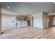 Spacious kitchen features an island, stainless steel appliances, and light wood floors, creating an inviting culinary space at 8606 Hotchkiss St, Littleton, CO 80125