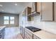 Close-up of a contemporary kitchen highlighting quartz countertops, stainless steel appliances, and modern design elements at 8606 Hotchkiss St, Littleton, CO 80125