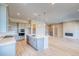 Bright, modern kitchen with a large island, stainless steel appliances, and open access to other rooms in the house at 8606 Hotchkiss St, Littleton, CO 80125