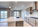 Contemporary kitchen featuring a large island, stainless steel appliances, and an abundance of natural light and wood floors at 8606 Hotchkiss St, Littleton, CO 80125