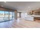 Open-concept living space with kitchen, bright with natural light, and sliding doors to the outside patio at 8606 Hotchkiss St, Littleton, CO 80125