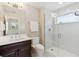 A modern bathroom with a glass-enclosed shower and stylish tile work, and dark wood cabinets at 115 S Glencoe, Denver, CO 80246