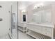 Bright bathroom featuring dual vanities, marble countertops, and a frameless glass shower at 115 S Glencoe, Denver, CO 80246