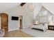 Primary bedroom suite boasts vaulted ceiling, chandelier, wood floors, ensuite bathroom, and walk-in closet at 115 S Glencoe, Denver, CO 80246