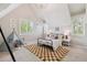 bedroom features a geometric rug, bright natural light, and a playful tent at 115 S Glencoe, Denver, CO 80246