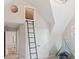 Unique bedroom features a ladder to an attic window and a fun and comfortable atmosphere at 115 S Glencoe, Denver, CO 80246