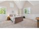 A cozy bedroom with wainscoting, a chandelier, and large windows with plantation shutters at 115 S Glencoe, Denver, CO 80246