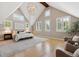 A vaulted-ceiling primary bedroom is filled with natural light from the many windows with shutter blinds at 115 S Glencoe, Denver, CO 80246