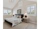 Cozy bedroom with neutral decor, black bed frame, vaulted ceiling, white trim, and carpet at 115 S Glencoe, Denver, CO 80246