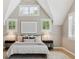 Bedroom with a vaulted ceiling features a modern chandelier, plantation shutters, neutral decor, and lots of natural light at 115 S Glencoe, Denver, CO 80246
