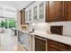 Butler's pantry features wine refrigerator, white cabinets, and under cabinet lighting at 115 S Glencoe, Denver, CO 80246
