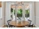 Cozy dining area with round table and a view of the outdoor patio through sliding glass doors at 115 S Glencoe, Denver, CO 80246