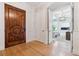 Elegant entryway with hardwood floors, a decorative front door, and an open view to the living room at 115 S Glencoe, Denver, CO 80246