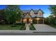 Charming two-story home featuring a stone facade, arched entryway, and manicured landscaping at 115 S Glencoe, Denver, CO 80246