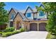Elegant home featuring stone accents, an arched entryway, and a convenient two-car attached garage at 115 S Glencoe, Denver, CO 80246