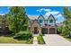 Beautiful stone and stucco home with a well-manicured lawn and an attached two-car garage at 115 S Glencoe, Denver, CO 80246