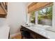 Bright home office nook with built-in desk, a comfortable chair, and natural light at 115 S Glencoe, Denver, CO 80246